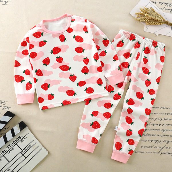 Kinderpyjama met aardbeien en roze figuren op witte achtergrond